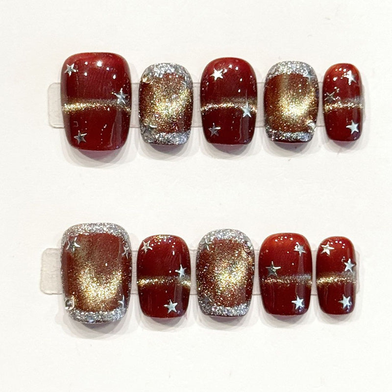 Festive handmade squoval nails with burgundy-gold gradient, silver stars & glitter - Holiday elegance, reusable - Applies in 15 minutes