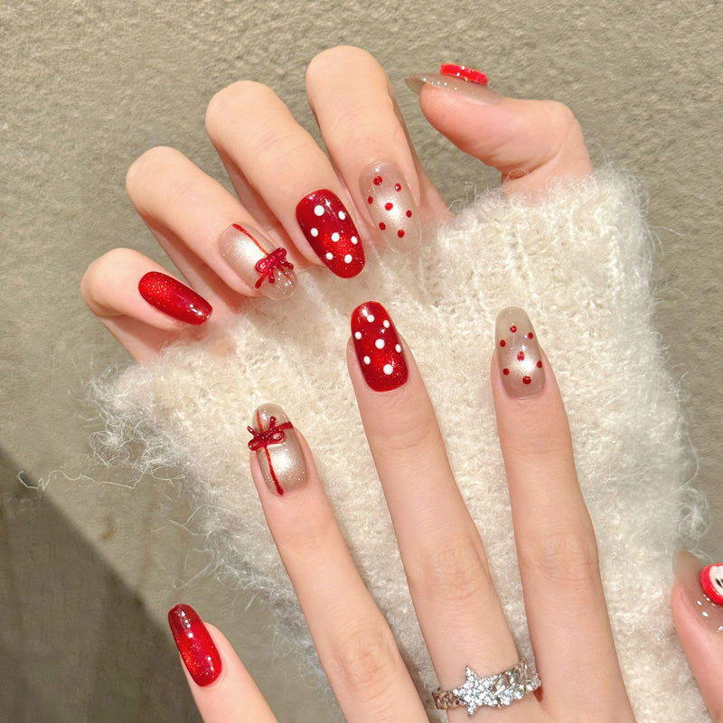 Festive oval nails with 3D apple, red bow, polka dots & glossy red - perfect for sweet apple bow polka dot Christmas charm & holiday celebrations