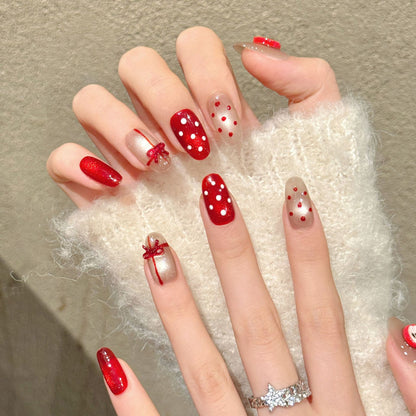 Festive oval nails with 3D apple, red bow, polka dots & glossy red - perfect for sweet apple bow polka dot Christmas charm & holiday celebrations