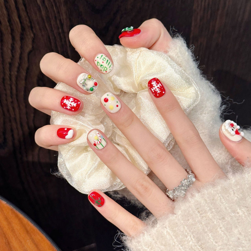 Festive oval press-on nails with 3D Santa, snowflakes, ornaments, silver bow & holly - perfect for cozy Christmas holiday cheer & warm celebrations