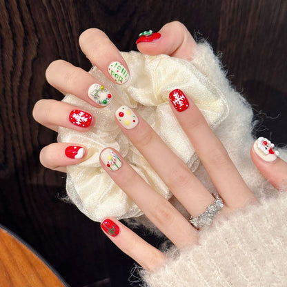 Festive oval press-on nails with 3D Santa, snowflakes, ornaments, silver bow & holly - perfect for cozy Christmas holiday cheer & warm celebrations