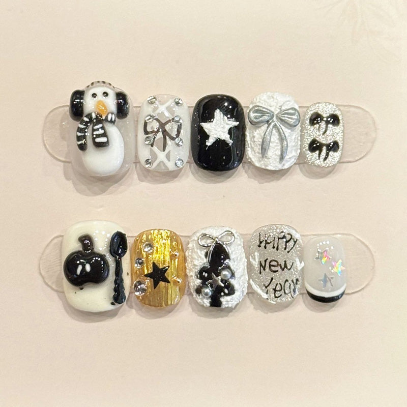 Festive oval press-on nails with 3D penguin, balloons, silver bows & Happy New Year text - perfect for New Year celebrations & countdown parties