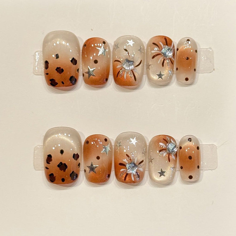 Fierce yet practical short squoval press-ons with leopard print, metallic stars & rhinestone flower - handcrafted caramel nail art