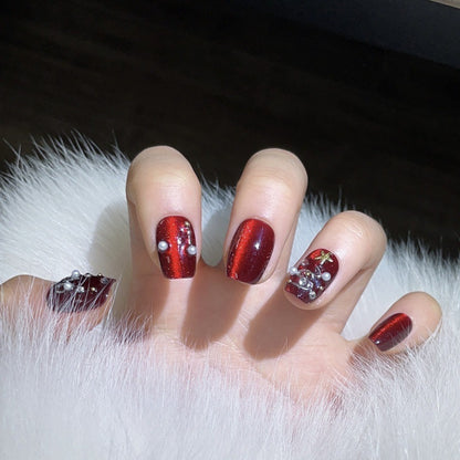 Glamorous coffin short press-on nails with ruby red chrome, pearls & crystals - perfect for ruby Christmas glamour & festive celebrations