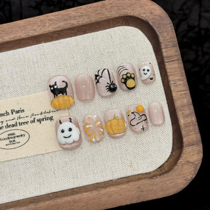 Handcrafted Halloween nails featuring 3D orange pumpkin embellishments, sweet ghost characters - oval short shape for cute style