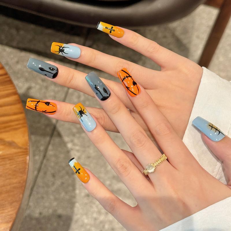 Handcrafted Halloween nails featuring bold pumpkin jack-o'-lanterns, creepy spiders, mystical crosses - coffin long shape collection