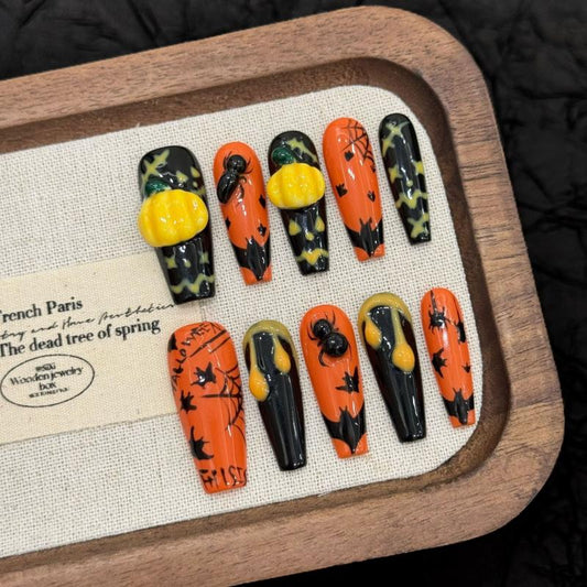Handcrafted Halloween nails featuring enchanting witch figures, 3D pumpkin embellishments, spiders - coffin long shape for witchy elegance