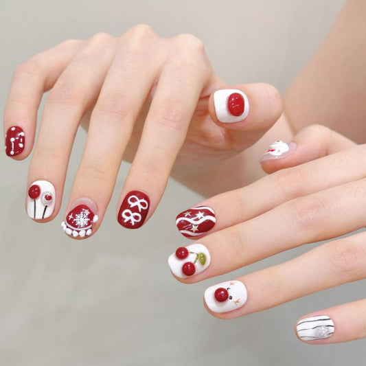 Handcrafted Halloween nails featuring red cherry designs, elegant skull patterns, snowflakes - squoval short shape for sweet gothic style