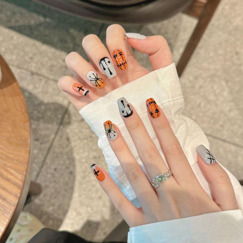 Handcrafted Halloween nails featuring spooky spiders, ghost characters, jack-o'-lanterns - coffin medium shape collection for Halloween parties