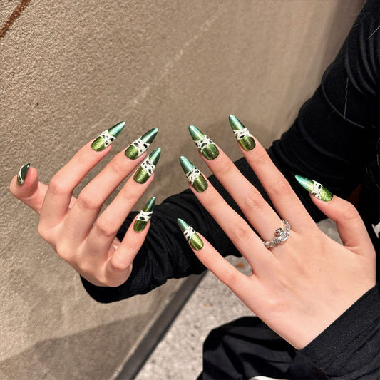 Handcrafted stiletto nails with mirror-like green chrome finish and artistic marble details. Perfect for luxury events and glamour.