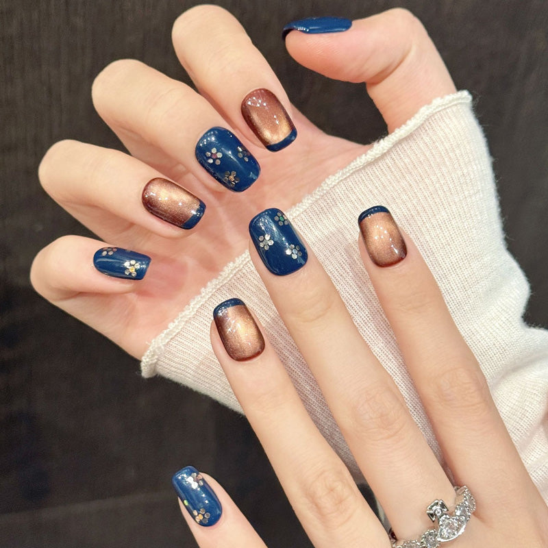 Japanese-inspired short squoval nails with twilight blue, drifting cherry petals & bronze glow - handcrafted elegant collection