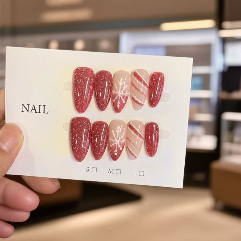 KAPOWNAILS almond nails featuring festive winter design - burgundy sparkle, delicate snowflakes, candy cane stripes, handcrafted quality, 10-piece set