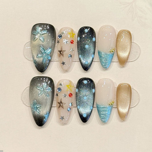 KAPOWNAILS almond nails featuring ocean design - iridescent butterfly, sparkling stars, black-teal gradient, crystal accents, handcrafted quality, 10-piece set