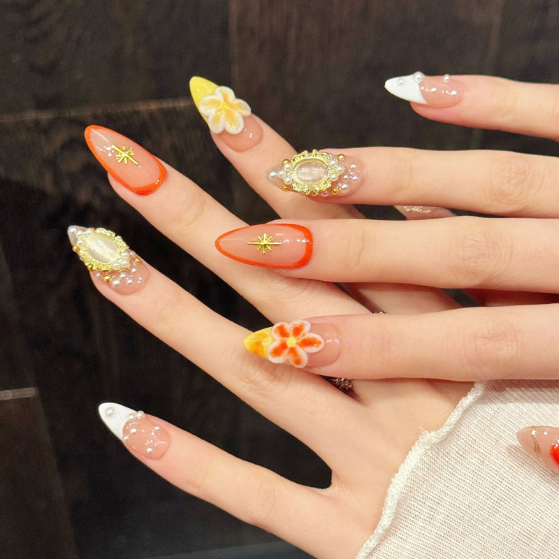 KAPOWNAILS almond nails featuring opulent design - delicate plumeria flowers, gold star, pearl border, red outline, handcrafted quality, 10-piece set