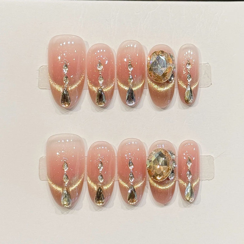 KAPOWNAILS almond nails featuring opulent design - sparkling crystal chain, champagne gold, large gemstone, rhinestone accents, handcrafted quality, 10-piece set