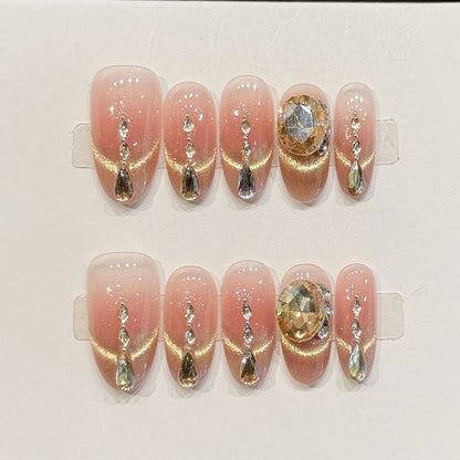 KAPOWNAILS almond nails featuring opulent design - sparkling crystal chain, champagne gold, large gemstone, rhinestone accents, handcrafted quality, 10-piece set