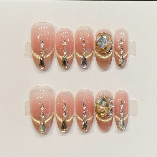 KAPOWNAILS almond nails featuring opulent design - sparkling crystal chain, champagne gold, large gemstone, rhinestone accents, handcrafted quality, 10-piece set