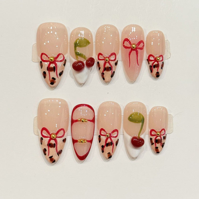 KAPOWNAILS almond nails featuring playful design - glossy cherries, elegant bows, trendy leopard, gold bead chains, handcrafted quality, 10-piece set