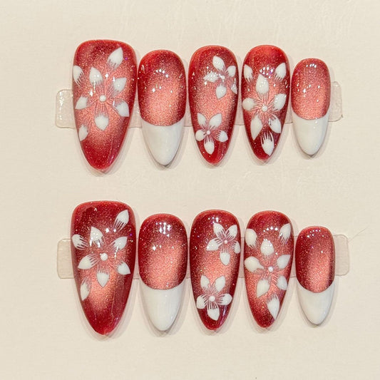 KAPOWNAILS almond nails featuring romantic design - sparkling red-pink shimmer, delicate white flowers, gold centers, French tips, handcrafted quality, 10-piece set
