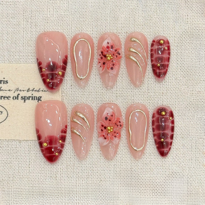 KAPOWNAILS almond nails featuring sophisticated floral design - delicate burgundy flowers, gold swirl lines, tortoiseshell, handcrafted quality, 10-piece set