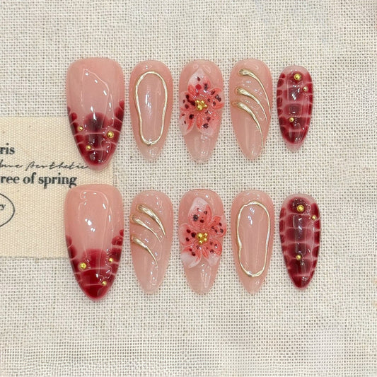KAPOWNAILS almond nails featuring sophisticated floral design - delicate burgundy flowers, gold swirl lines, tortoiseshell, handcrafted quality, 10-piece set