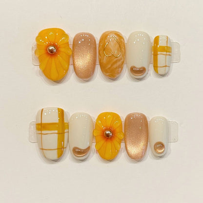 KAPOWNAILS almond nails featuring sunny design - vibrant yellow flower, playful plaid grid, heart accents, gold sparkle, handcrafted quality, 10-piece set