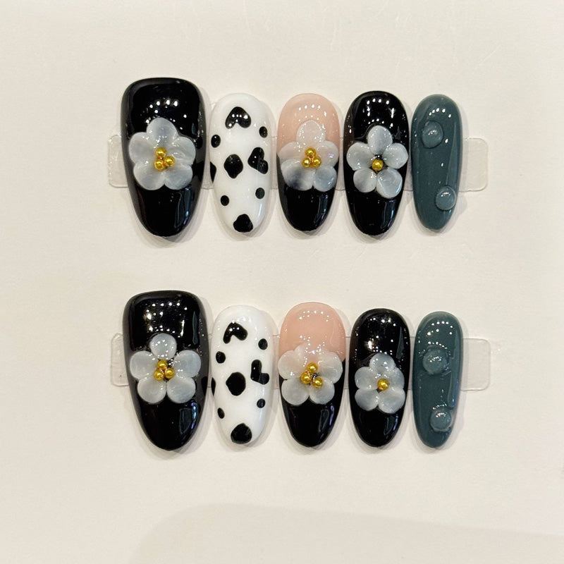 KAPOWNAILS almond nails featuring trendy design - delicate grey flower, cow print pattern, black gloss, gold centers, handcrafted quality, 10-piece set