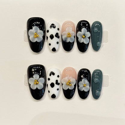 KAPOWNAILS almond nails featuring trendy design - delicate grey flower, cow print pattern, black gloss, gold centers, handcrafted quality, 10-piece set