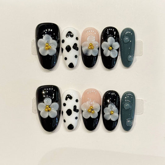 KAPOWNAILS almond nails featuring trendy design - delicate grey flower, cow print pattern, black gloss, gold centers, handcrafted quality, 10-piece set