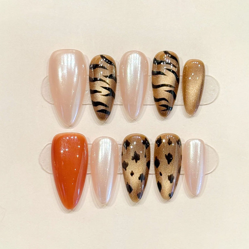 KAPOWNAILS almond nails featuring wild design - black zebra stripes, leopard spots, iridescent pearl, gold shimmer, handcrafted quality, 10-piece set
