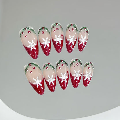 KAPOWNAILS almond nails featuring winter wonderland design - snowflakes, festive holly, red-to-nude gradient, handcrafted quality, 10-piece set"