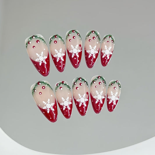 KAPOWNAILS almond nails featuring winter wonderland design - snowflakes, festive holly, red-to-nude gradient, handcrafted quality, 10-piece set"
