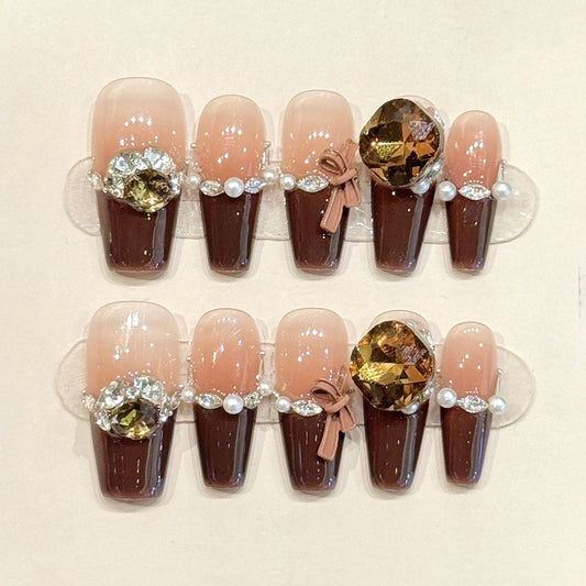 KAPOWNAILS coffin nails featuring opulent design - large amber crystals, white pearl chains, chocolate French tips, handcrafted quality, 10-piece luxury set