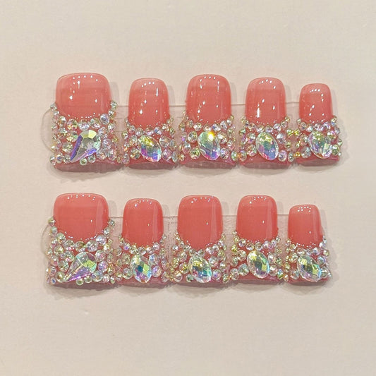 KAPOWNAILS duck nails featuring luxury design - vibrant coral pink, full rhinestone border, iridescent AB crystals, handcrafted quality, 10-piece glam set
