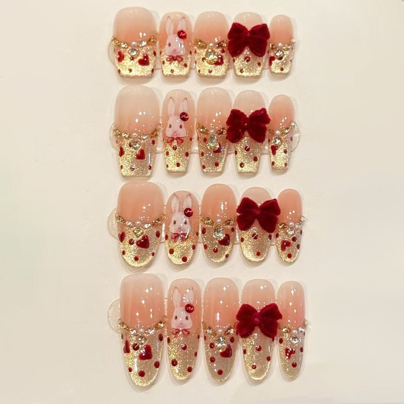 KAPOWNAILS nails featuring opulent romantic design - burgundy velvet bow, champagne gold tips, ruby gemstones, handcrafted quality, 10-piece luxury set