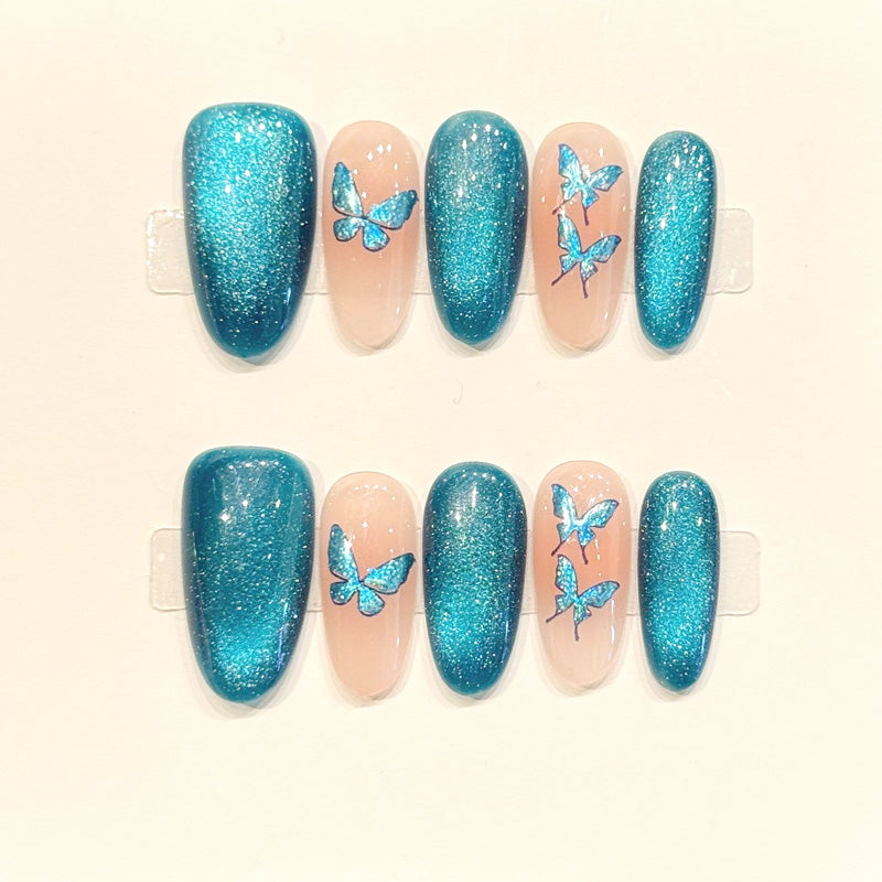KAPOWNAILS oval nails featuring butterfly design - holographic teal butterflies, metallic shimmer, translucent jelly, handcrafted quality, 10-piece set