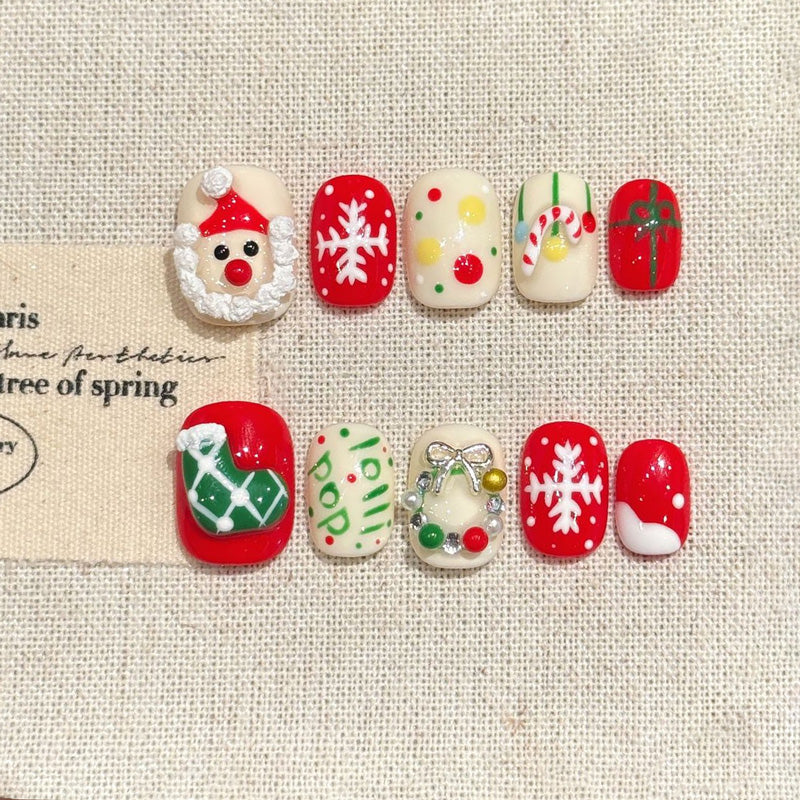 KAPOWNAILS oval nails featuring charming Christmas design - adorable Santa, white snowflakes, playful ornaments, handcrafted quality, 10-piece festive set