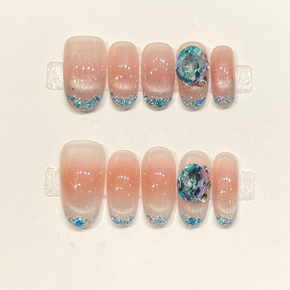 KAPOWNAILS oval nails featuring ocean design - iridescent blue crystal, sparkling glitter tips, soft gradient, shell fragments, handcrafted quality, 10-piece set