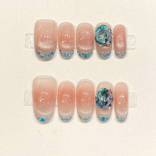 KAPOWNAILS oval nails featuring ocean design - iridescent blue crystal, sparkling glitter tips, soft gradient, shell fragments, handcrafted quality, 10-piece set