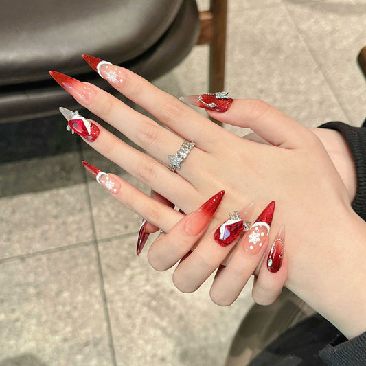 KAPOWNAILS stiletto long nails featuring luxurious Christmas design - burgundy sparkle, white snowflakes, ruby gemstone, handcrafted quality, 10-piece set