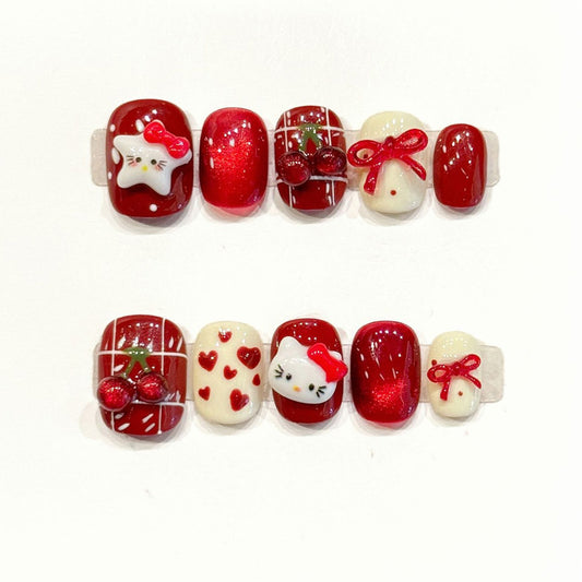 Kawaii holiday squoval press-ons with 3D Hello Kitty, dimensional cherries & satin bows - handcrafted Christmas cute nail art