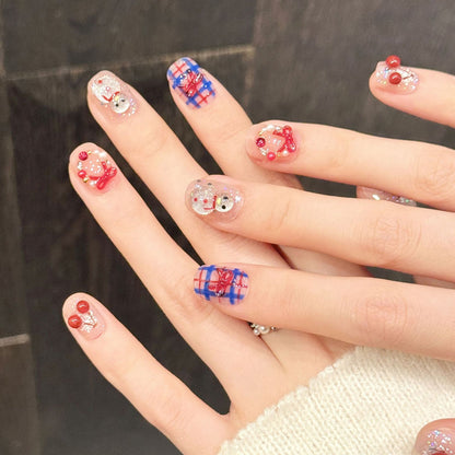 Playful festive nails featuring dimensional cherry charms, sparkling snowman & cozy plaid pattern - cute 10-piece holiday set