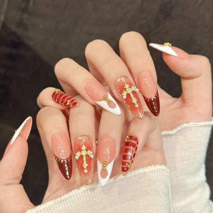 Premium almond nails for glamorous elegance - deep burgundy gloss, luxurious gold cross, pearl details, chic stripes, gold beads, perfect for luxury celebrations