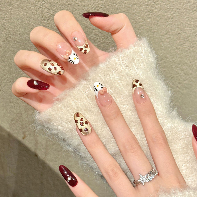 Premium almond nails for kawaii fun - 3D kitty character, playful leopard print, luxurious burgundy, sparkling crystals, perfect for cute celebrations