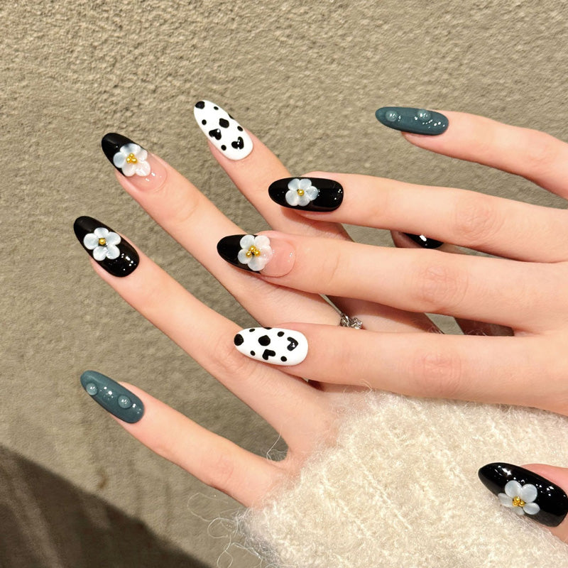 Premium almond nails for modern elegance - 3D grey flower, black white cow print, glossy black, sparkling gold, perfect for contemporary celebrations