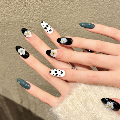 Premium almond nails for modern elegance - 3D grey flower, black white cow print, glossy black, sparkling gold, perfect for contemporary celebrations
