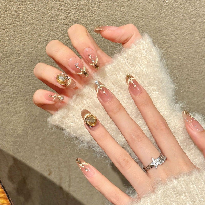 Premium almond nails for sophisticated luxury - crystal rhinestone chain, gold shimmer, champagne gemstone, perfect for elegant celebrations