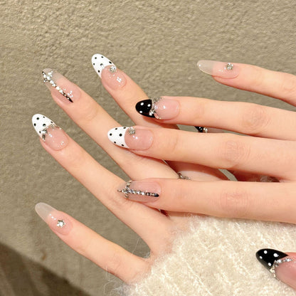 Premium almond nails for timeless elegance - black & white polka dots, crystal crown accents, elegant rhinestone borders, perfect for chic celebrations
