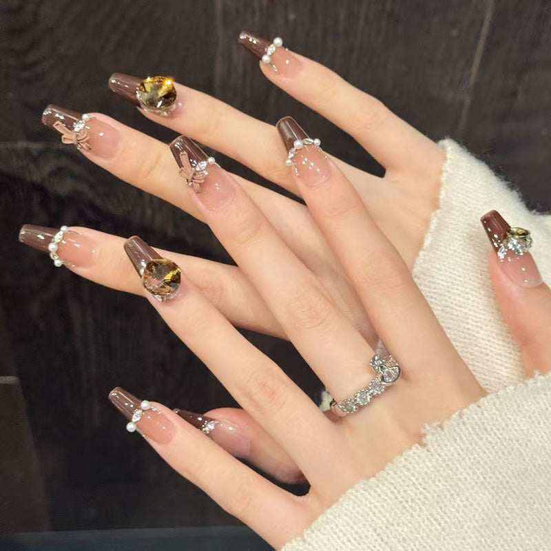 Premium coffin nails for elegant sophistication - crystal rhinestones, pearl borders, brown French manicure, delicate bow, perfect for luxury celebrations