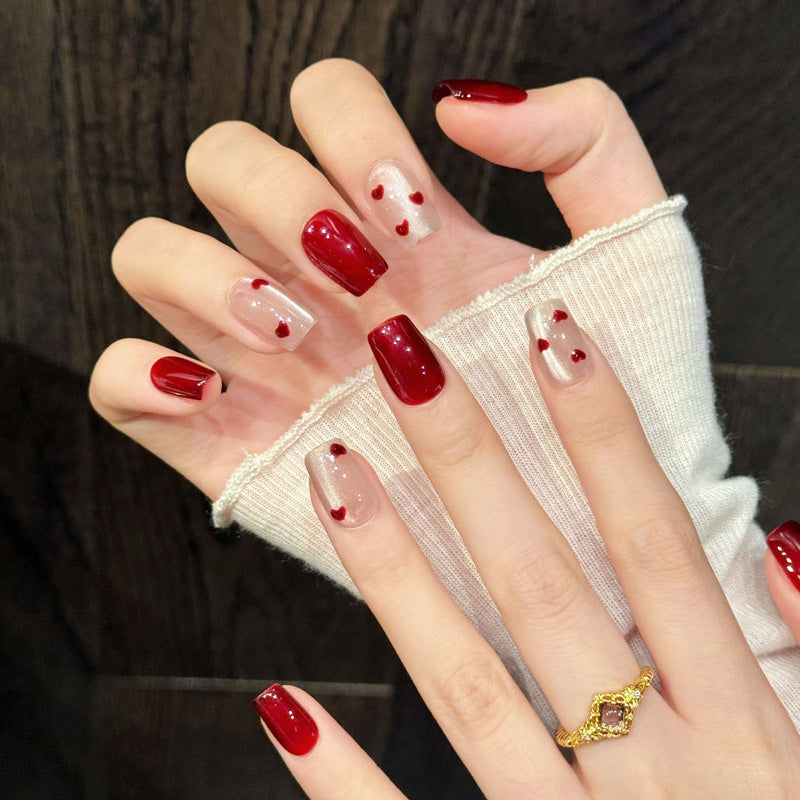 Premium coffin nails for romantic elegance - 3D glossy hearts, jelly base, red-to-nude ombre, sparkling rhinestones, perfect for Valentine's celebrations